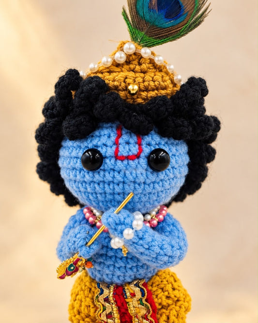 Close-up of Handmade Crochet Krishna Ji showing the face, crown, beadwork and flute
