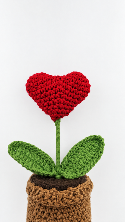 Angled view of Crimson Heart Bloom Pot showing the red heart, green leaves and crochet pot.