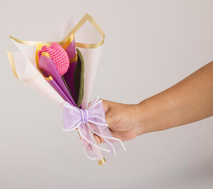 Wrapped in Love – Pink Tulip held in hand for scale