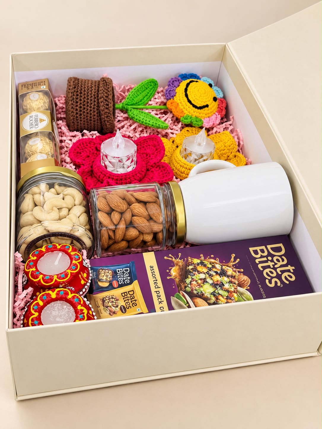 Angled view of Festive Smiles gift box showing the crochet flower, white mug, almond and cashew jars, festive lights and chocolates