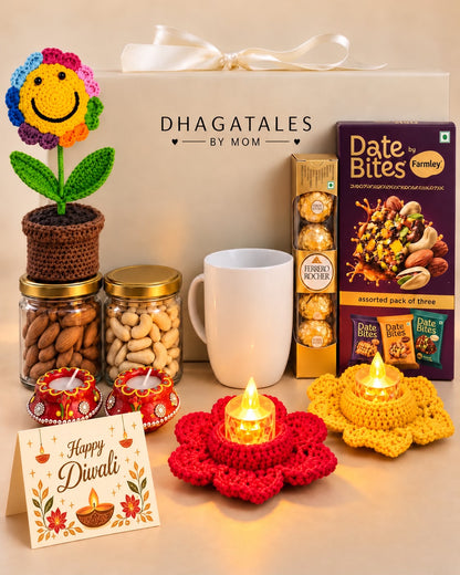 Festive Smiles hamper with illuminated LED tealights, rainbow crochet flower pot, white mug, dry fruits, chocolates and two clay diyas