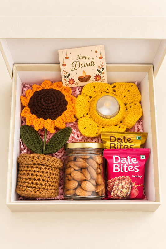 Top view of the Golden Glow hamper arranged in an ivory gift box with pink paper filling